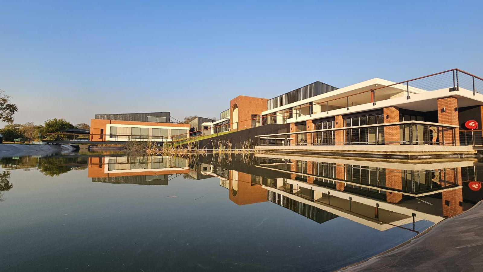 Insect Science offices and laboratories reflected in the pond by day