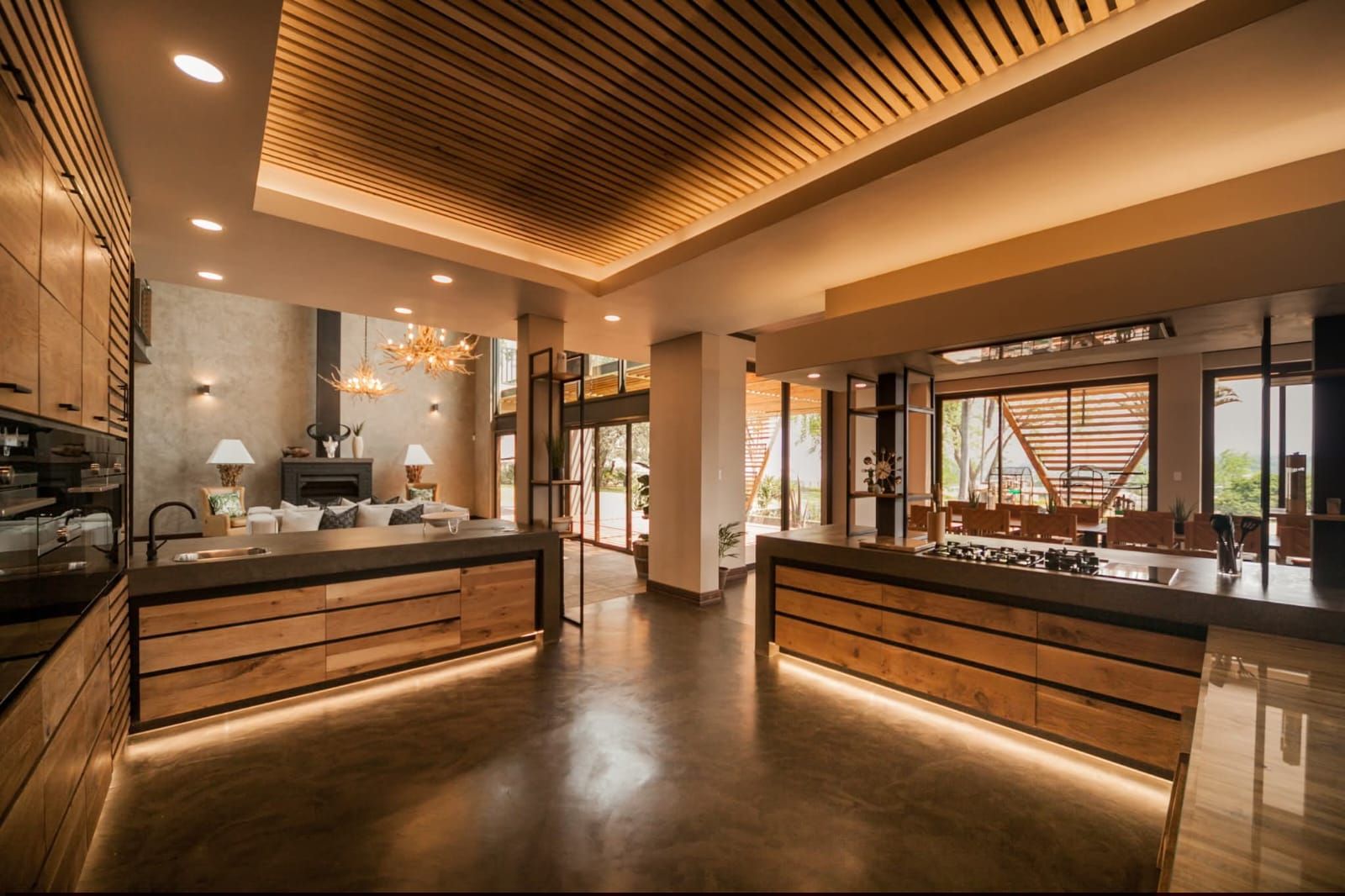 Kitchen with a lit timber-slat ceiling